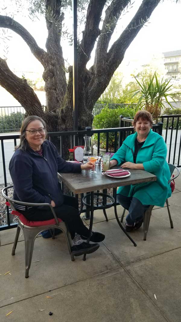 Kris and Deb drinking on patio